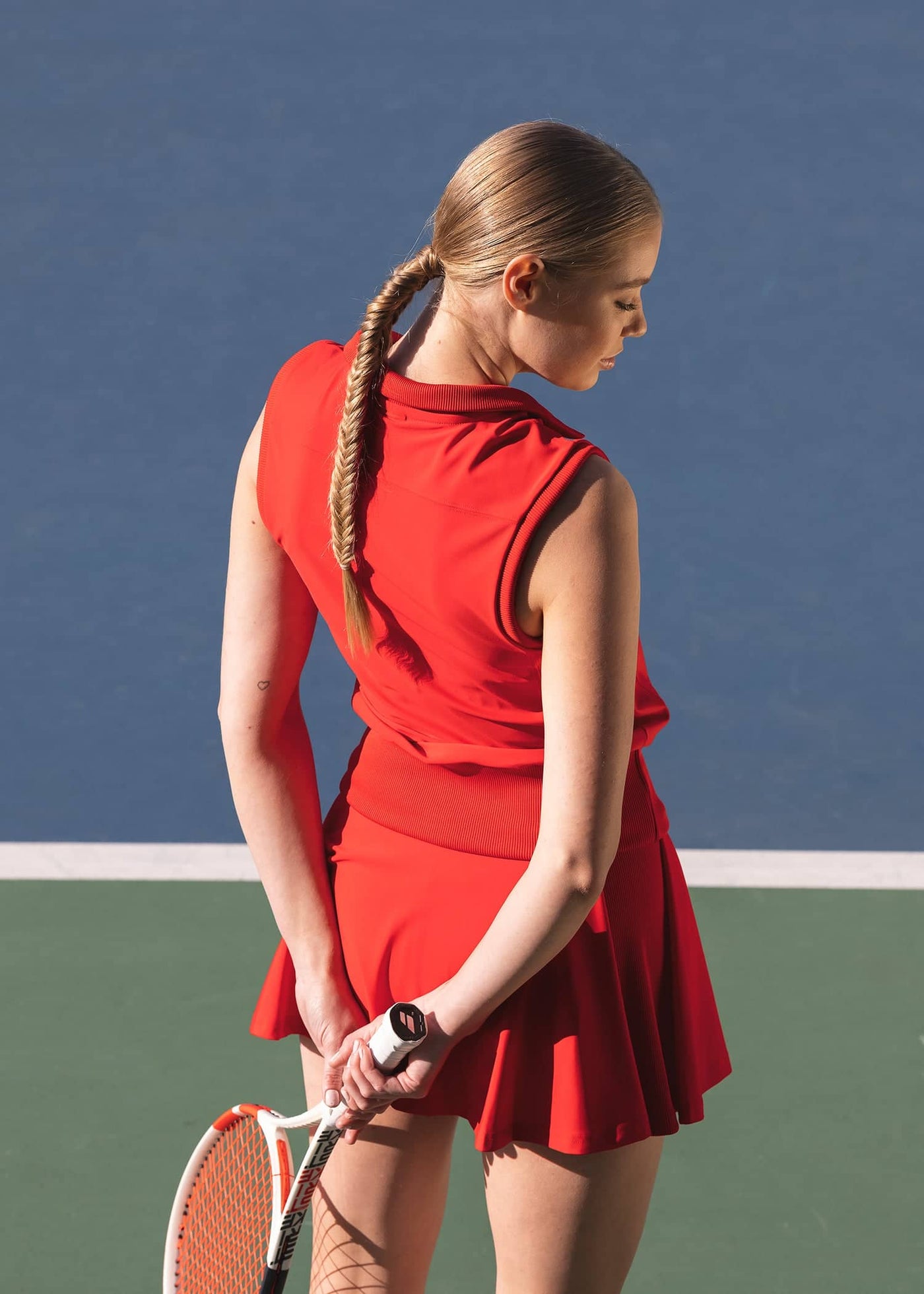 Backside of women's red tennis tank named after Margaret Court