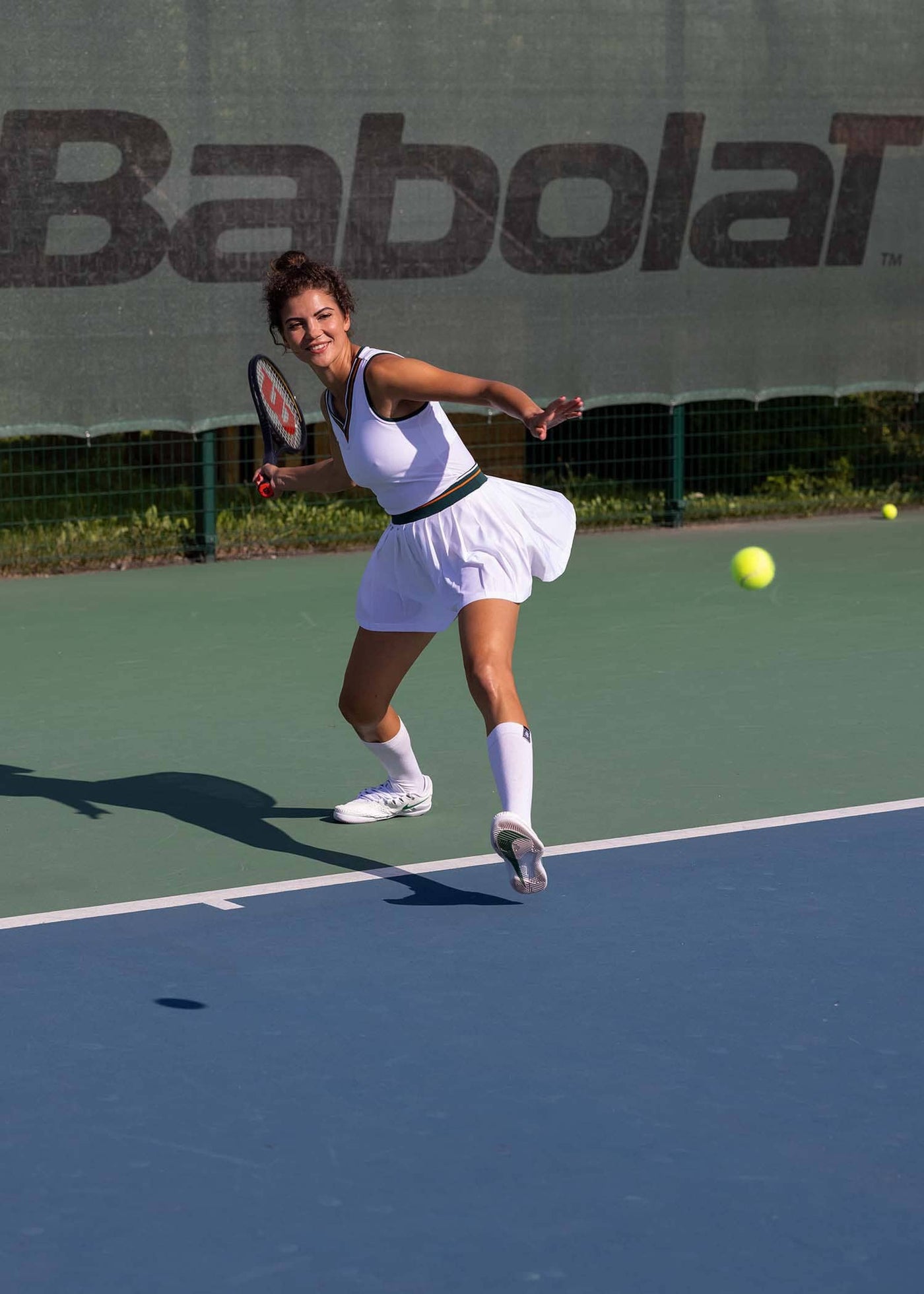 Model playing wearing women's tennis skirt named after Kim Clijsters